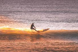 man surfing | Ward Realty Topsail Island