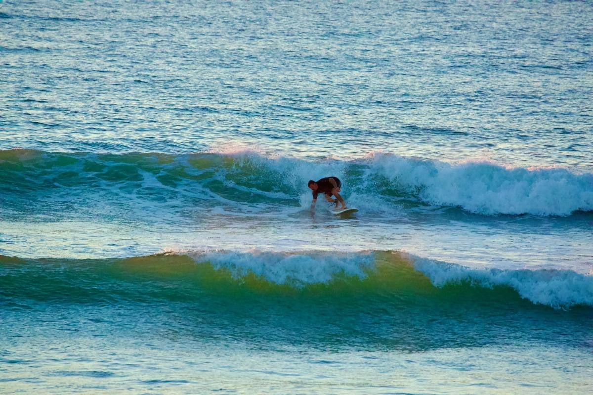 group of friends surfing | Ward Realty Topsail Island